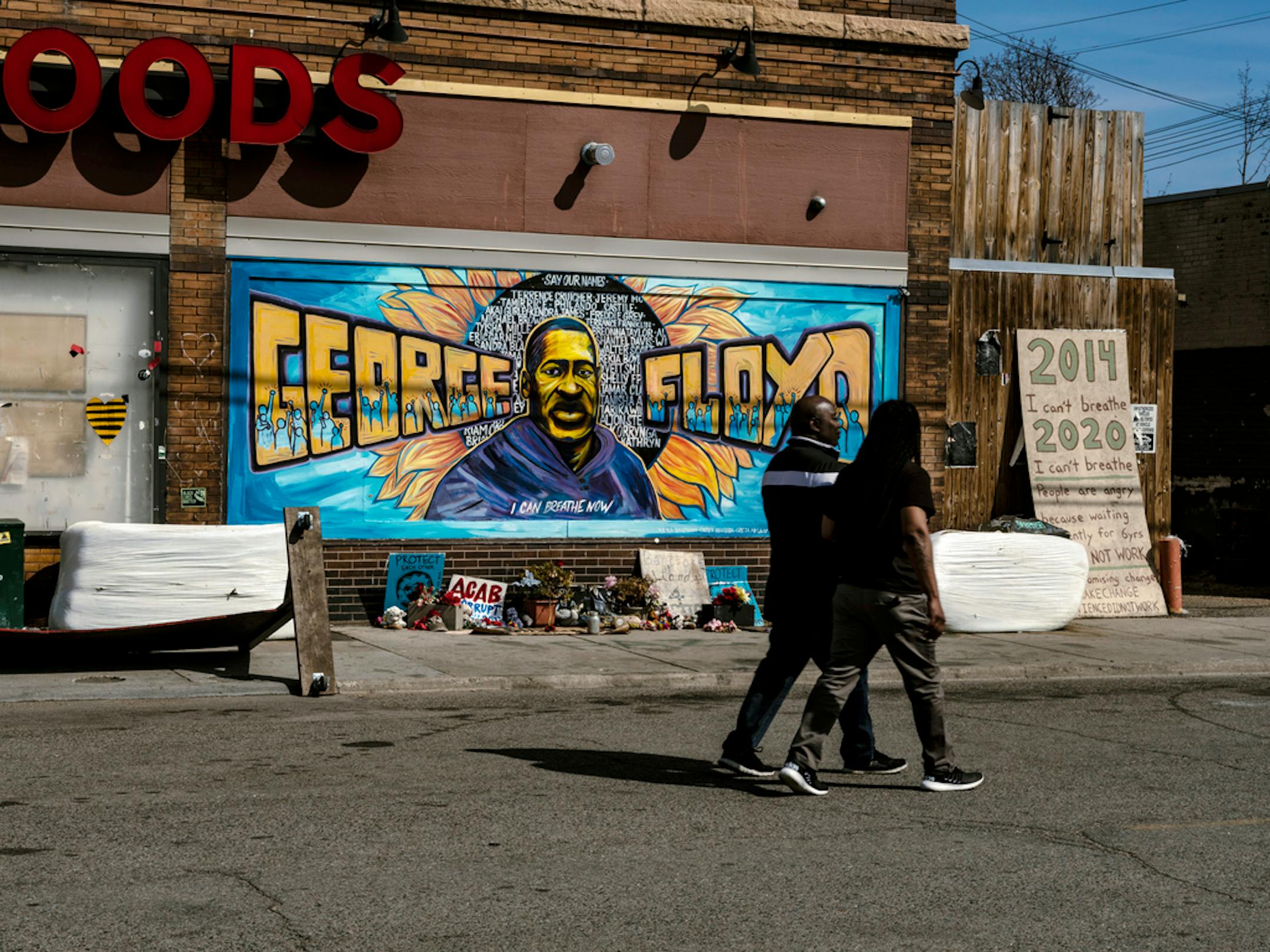 FILE — People walk near a memorial to George Floyd outside of Cup Foods convenience store in Minneapolis on Tuesday, April 6, 2021. Facebook on Monday, April 19, 2021, said it planned to limit posts that contain misinformation and hate speech related to the trial of Derek Chauvin, the former Minneapolis police officer charged with the murder of George Floyd, to keep them from spilling over into real-world harm. (Joshua Rashaad McFadden/The New York Times)