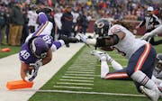 Minnesota Vikings fullback Zach Line (48) dove in the end zone passtChicago Bears defensive end Will Sutton (93) for a fourth quarter touchdown, Sunda
