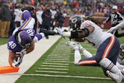 Minnesota Vikings fullback Zach Line (48) dove in the end zone passtChicago Bears defensive end Will Sutton (93) for a fourth quarter touchdown, Sunda