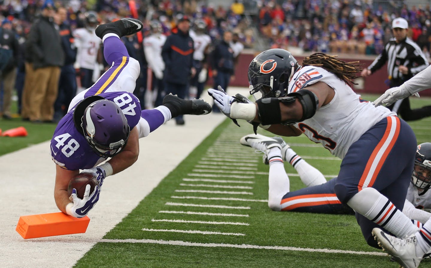 Minnesota Vikings fullback Zach Line (48) dove in the end zone passtChicago Bears defensive end Will Sutton (93) for a fourth quarter touchdown, Sunday December 20, 2015 in Minneapolis, MN.