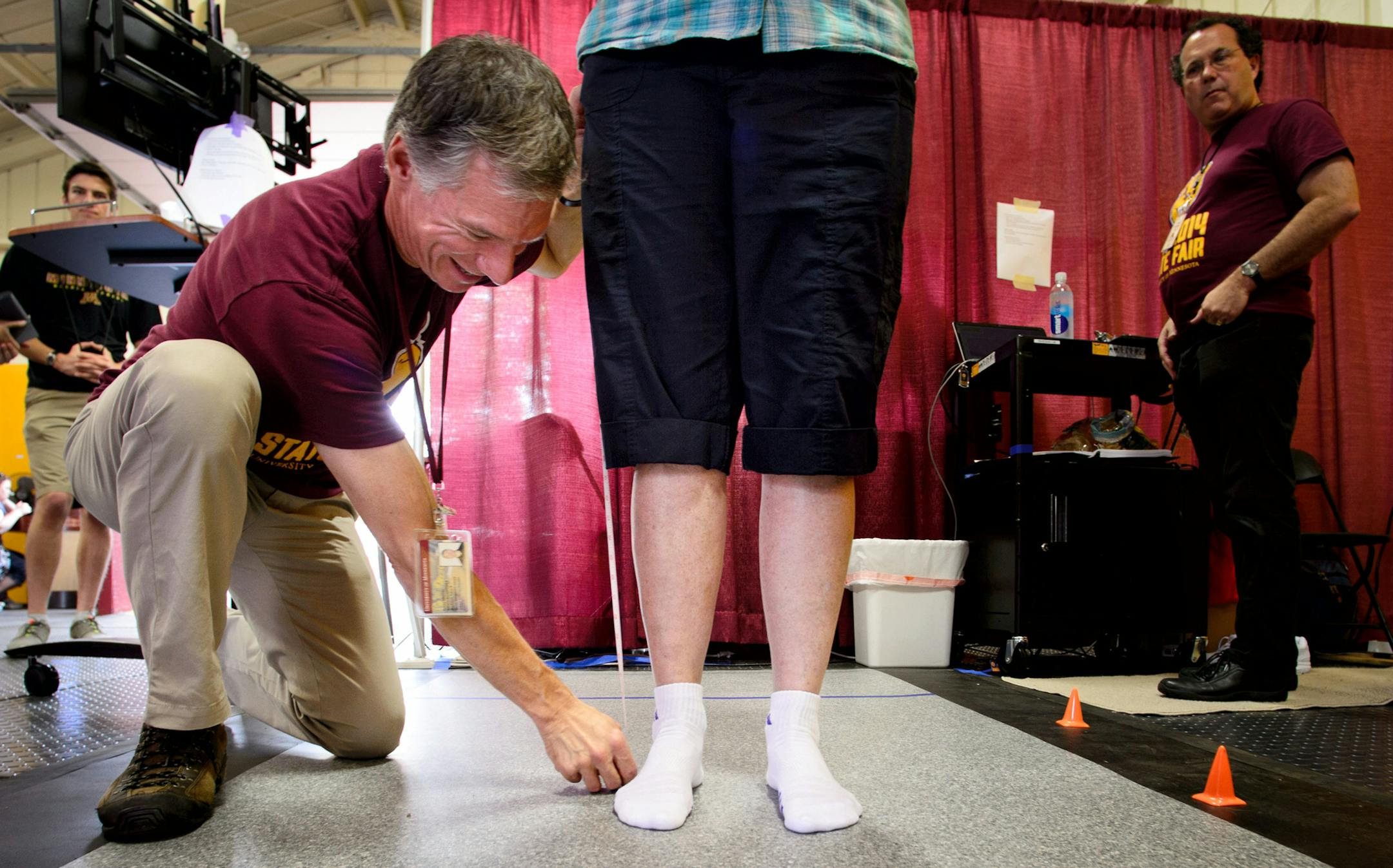 Before starting the test, Colum MacKinnon, of the movement disorders lab, University of Minnesota department of neurology, measured Sandy Ahlberg of Worthington for the length of her leg. Researchers from the department of neurology were measuring three things quality of walking, sense of smell and how well participants sleep to establish a baseline for testing patients for Parkinson's. Univeristy of Minnesota was giving fairgoers a chance to participate in ongoing studies Thursday at the Minnes