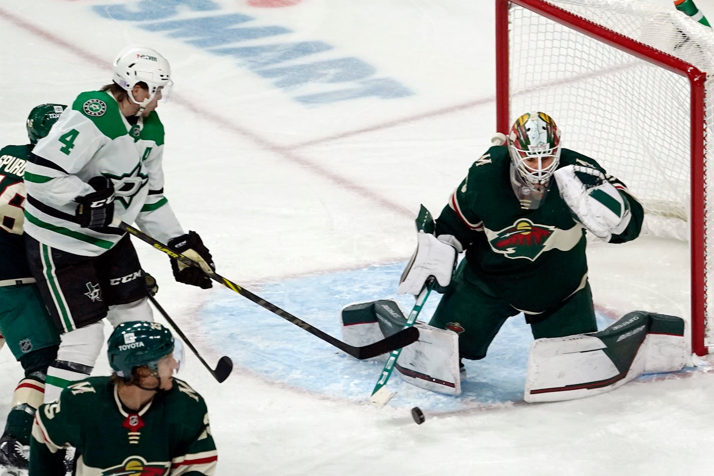 Minnesota Wild goalie Cam Talbot, right, stops a shot by Dallas Stars' Miro Heiskanen (4) in the third period of an NHL hockey game, Thursday, Nov. 18, 2021, in St. Paul, Minn. (AP Photo/Jim Mone)