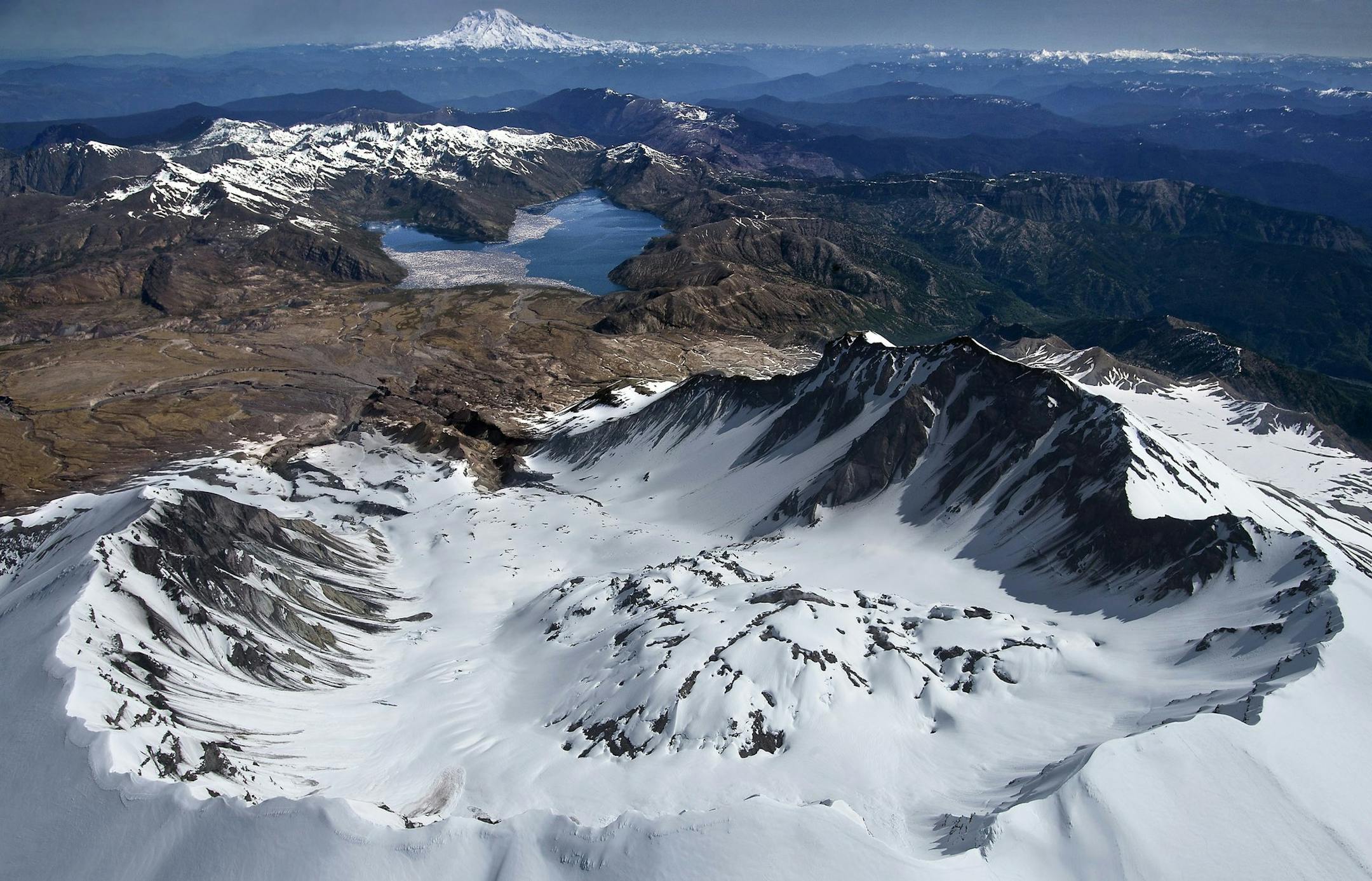 The panoramic and breathtaking view of the south rim of Mount Saint Helens, looking past a still venting lava dome north toward Spirit Lake and Mount Rainier, is awe inspiring but scientist are focused on a repressurizing of the magma chamber below the mountain. Scientist will be conducting explosive "active imaging events," and deploying thousands of seismic sensors and 70 passive sensing arrays this Spring and Summer as part of a battery of multidisciplinary imaging experiments collectively ca