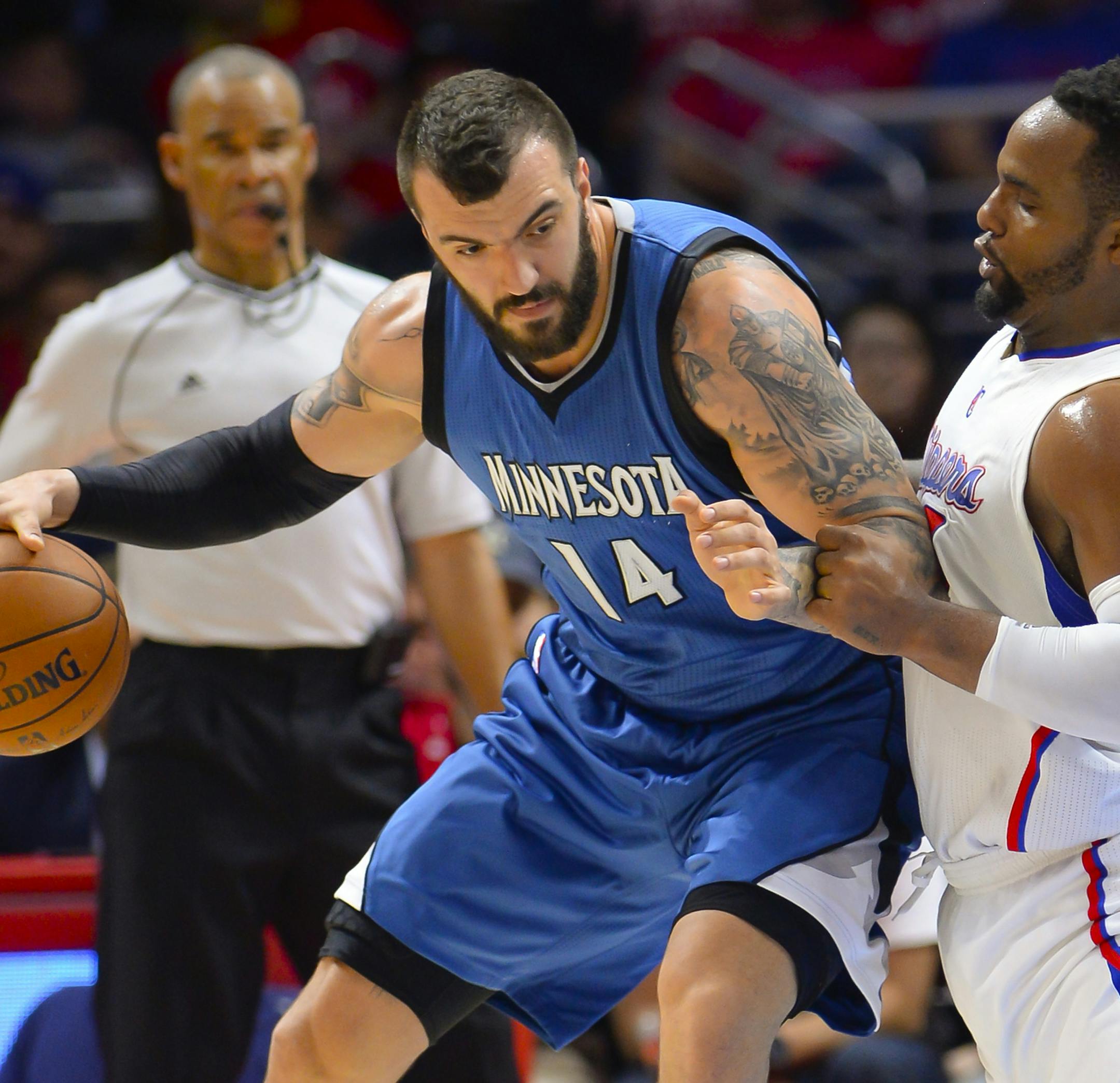 Minnesota Timberwolves center Nikola Pekovic, left, of Montenegro, battles Los Angeles Clippers forward Glen Davis (0) during the first half of an NBA basketball game Monday, March 9, 2015, in Los Angeles. (AP Photo/Gus Ruelas) ORG XMIT: MIN2015040220444569