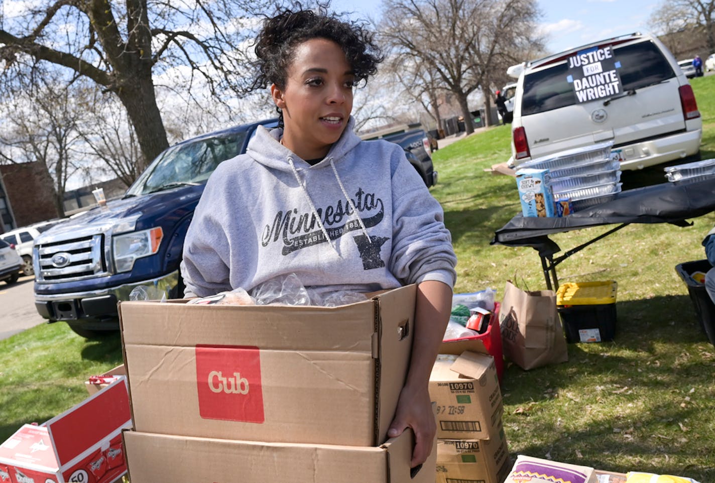 Rachel Nelson, with Twin Cities Relief, hauled a few boxes of food which would be served to community members at a barbecue outside the Kenyan Community Church in Brooklyn Center Saturday afternoon. ] AARON LAVINSKY • aaron.lavinsky@startribune.com