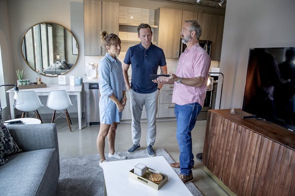 Minnestay's Lance Bondhus, right, talked with potential buyers Sophie Rupp and Harrison Wagenseil at the Sable in the North Loop.