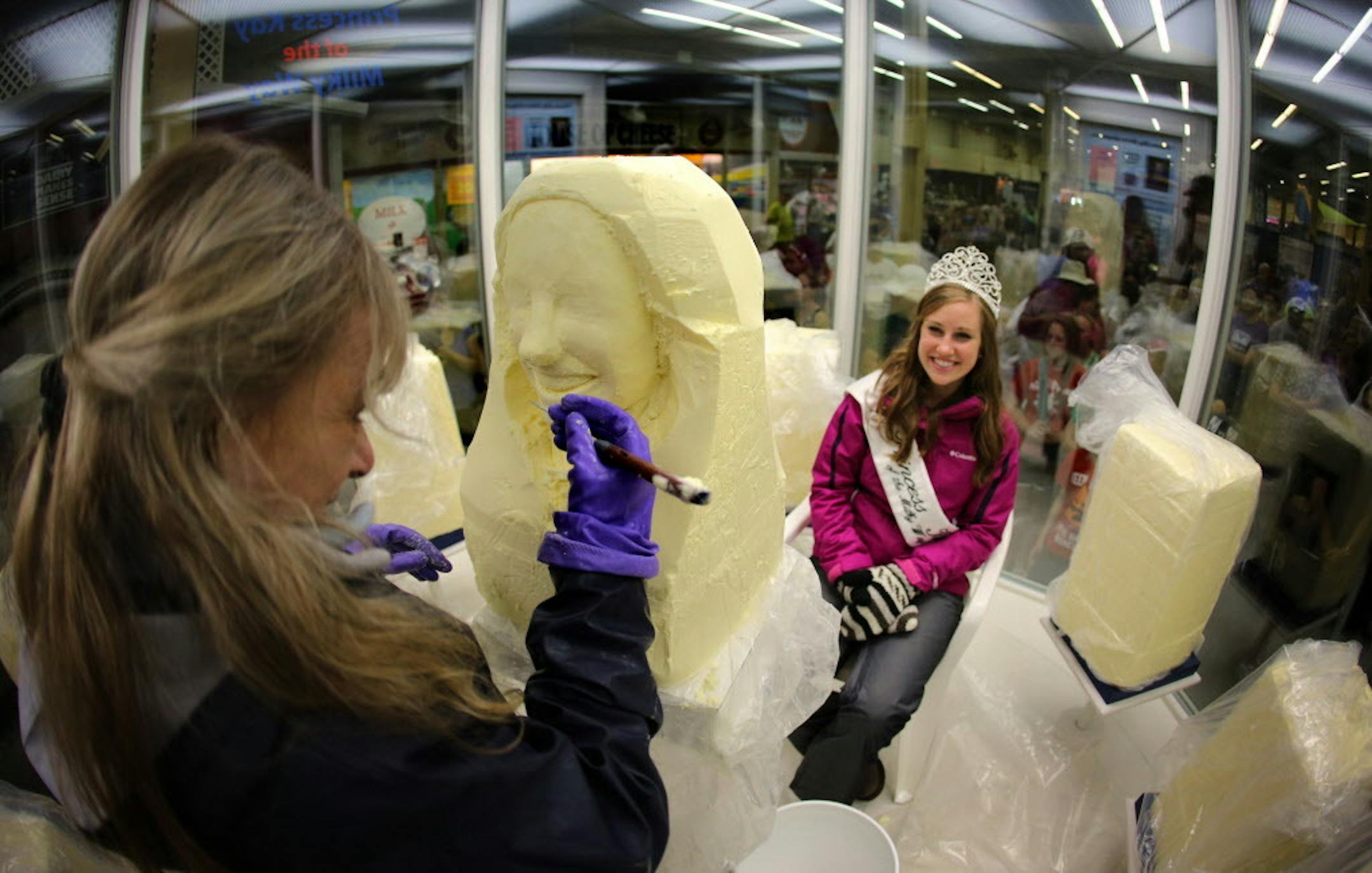 In this 2014 file photo, 19-year-old Jeni Haler, Princess Kay of the Milky Way, sits in the chilled confines of the butter sculpting cooler at the Minnesota State Fair.