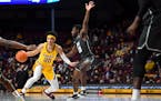 Minnesota Gophers guard E.J. Stephens (20) controls the ball as he was defended by Jacksonville Dolphins guard Gyasi Powell (10) during the first half
