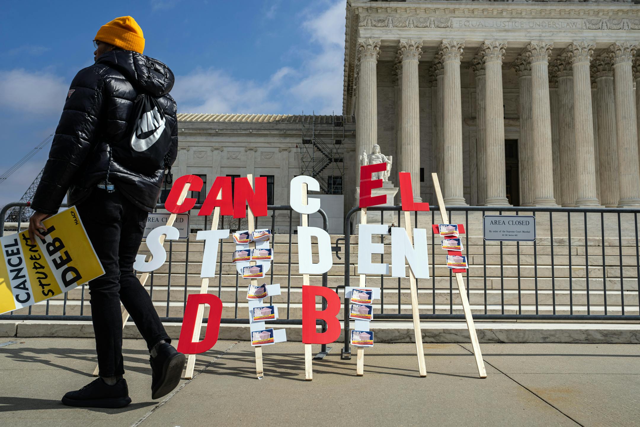 A sign outside the U.S. Supreme Court building reads, "Cancel student debt."