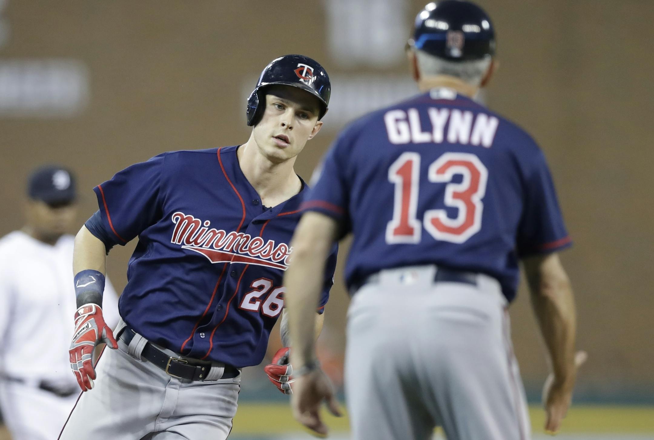 Minnesota Twins' Max Kepler is greeted by third base coach Gene Glynn after a solo home run during the third inning of a baseball game against the Minnesota Twins, Friday, Sept. 22, 2017, in Detroit. (AP Photo/Carlos Osorio)