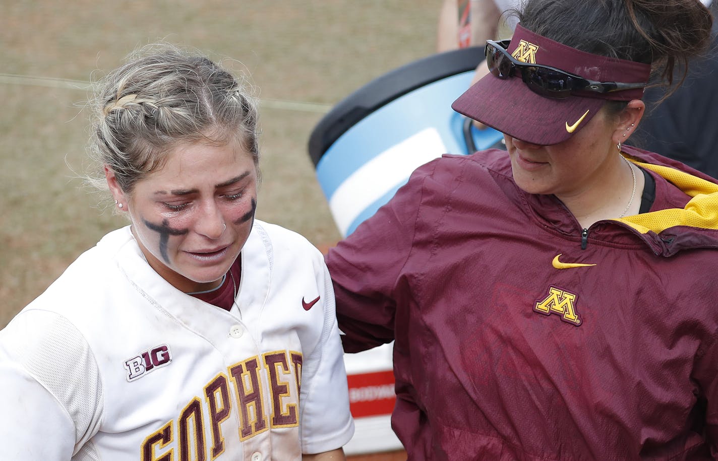 Minnesota&#x2019;s Allie Allie Arneson, left, is emotional following the loss to Washington during the Women's College World Series at ASA Hall of Fame Stadium in Oklahoma City on Saturday, June 1, 2019. Washington won 5-3. Photo by: Alonzo J. Adams