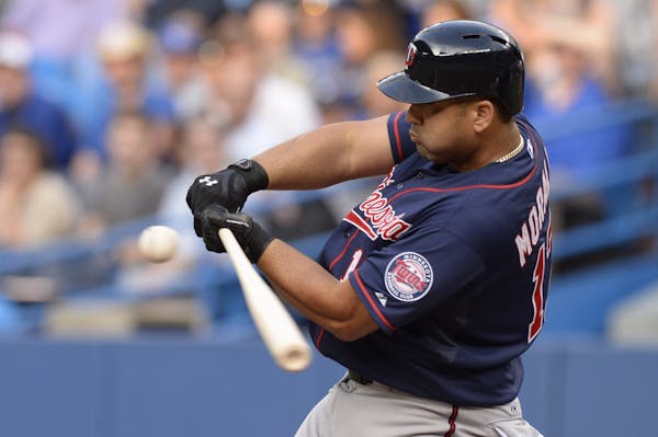 Minnesota Twins Kendrys Morales swings in his first at bat of the season where he struck out during the first inning of a baseball game against the To