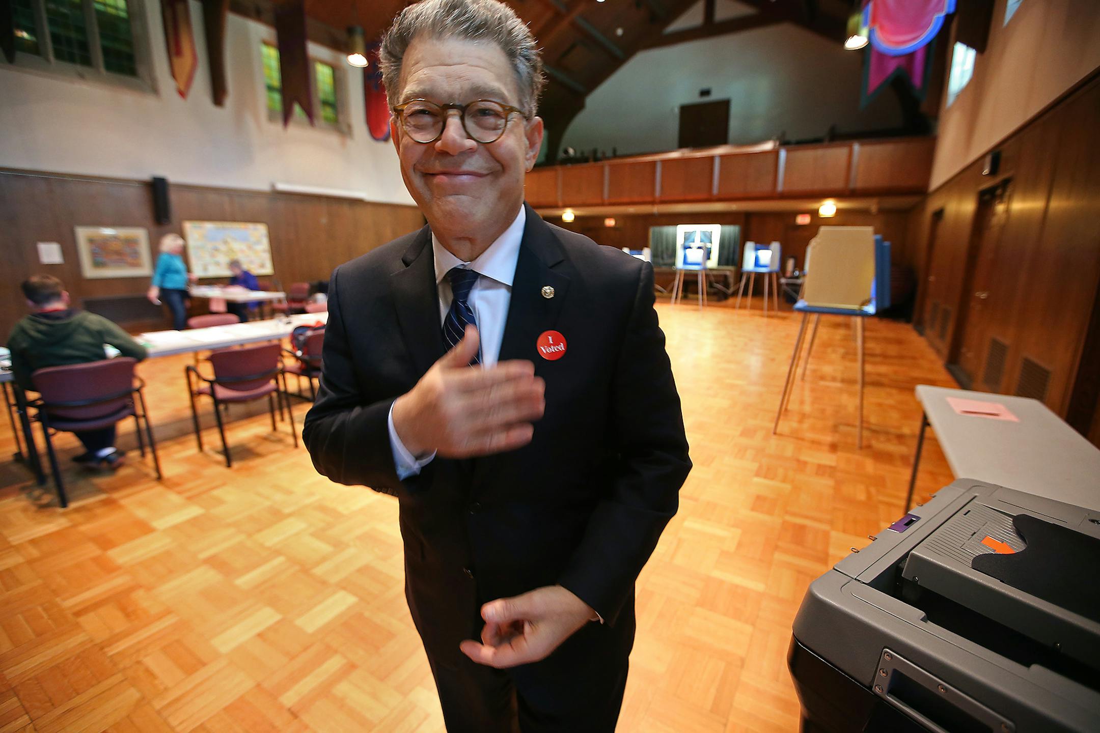 Sen. Al Franken, D-Minn., places his "I voted" sticker on his suit coat after he voted at Westminster Presbyterian Church in downtown Minneapolis, Tuesday, Aug. 12, 2014. (AP Photo/Star Tribune, Elizabeth Flores) ORG XMIT: MIN2014081220015557