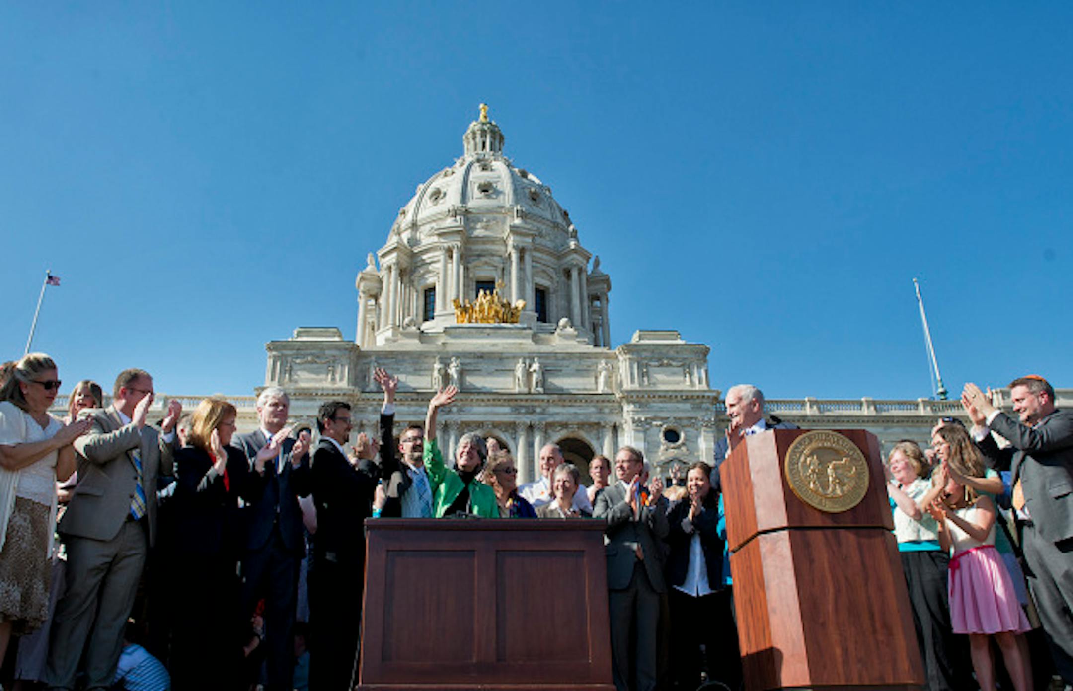 Governor Mark Dayton signed the marriage bill into law Tuesday, May 14, 2013  in front he the Capitol.  With him were bill authors  Senator Scott Dibble with husband Mark Leyva and Rep. Karen Clark with her partner Jacqueline Zita and all the legislators who voted yes.    ]   GLEN STUBBE * gstubbe@startribune.com