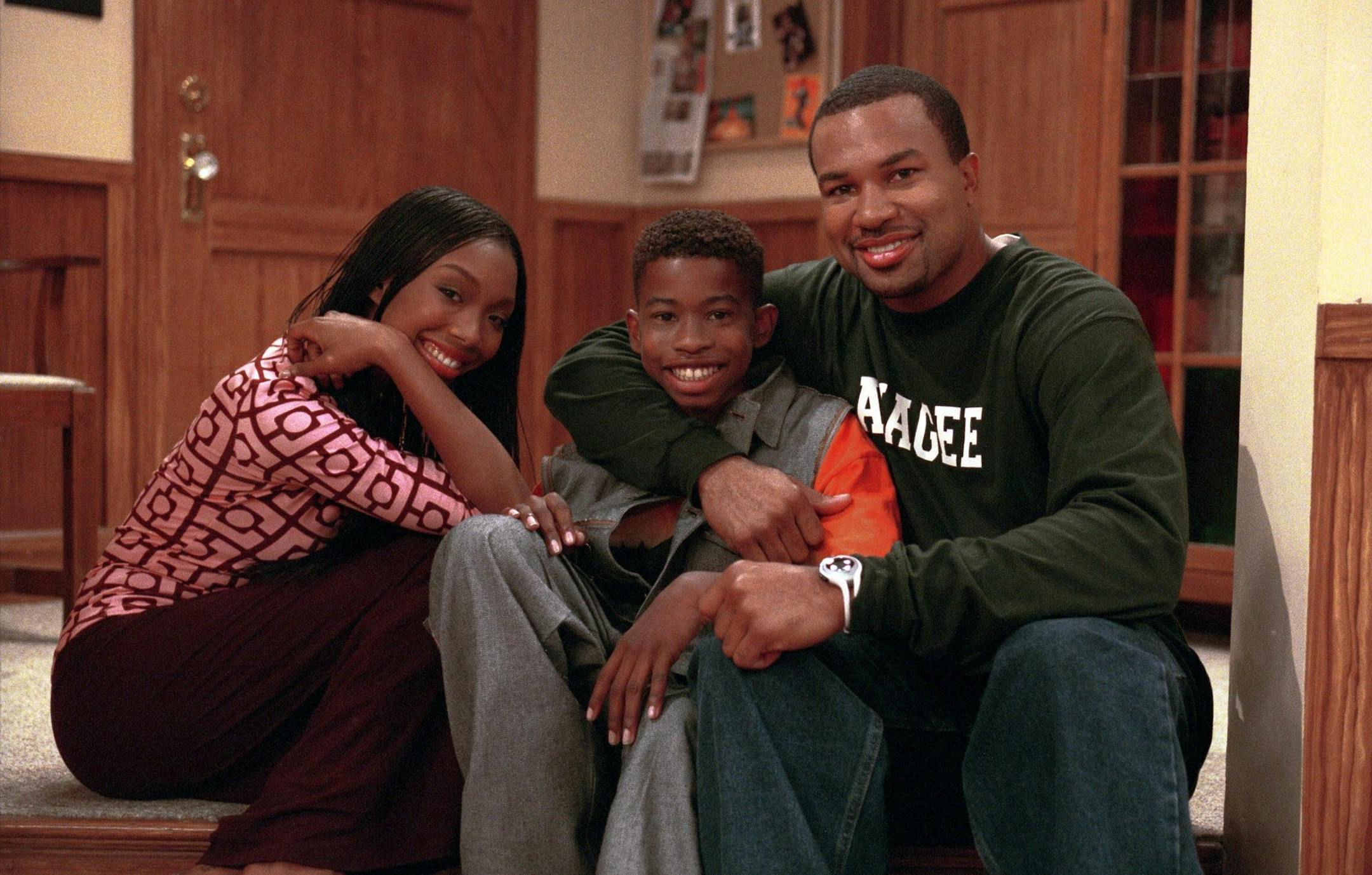 "Just The Two Of Us" -- World Champion Los Angeles Laker Derek Fisher guest stars on "Moesha," airing MONDAY, OCTOBER 9 (8:00-8:30 p.m. ET/PT) on UPN. Left to Right: Brandy, Marcus T. Paulk, Derek Fisher