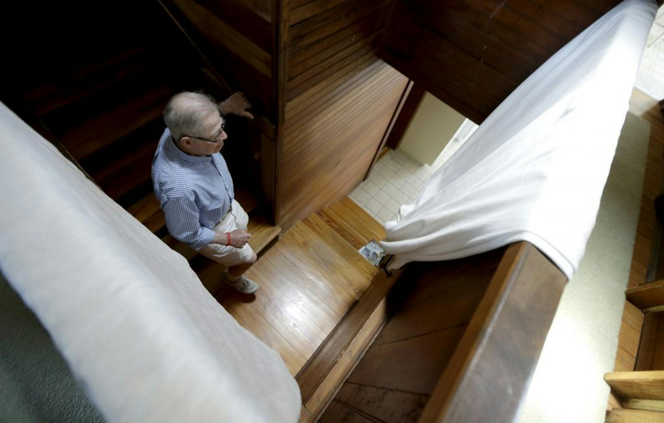 In this Friday, May 31, 2013 photo, Robert Post, 85, walks down the stairs in his home, in Mantoloking, N.J., which was flooded during Superstorm Sandy last year. Post has a pacemaker that needs to be checked once a month by phone, but the phone company refuses to restore the area's landlines after they were damaged by the storm. Verizon doesn�t want to replace washed-away lines and waterlogged underground cables because phone lines are outdated, it says. Meanwhile, the company is offering a wir