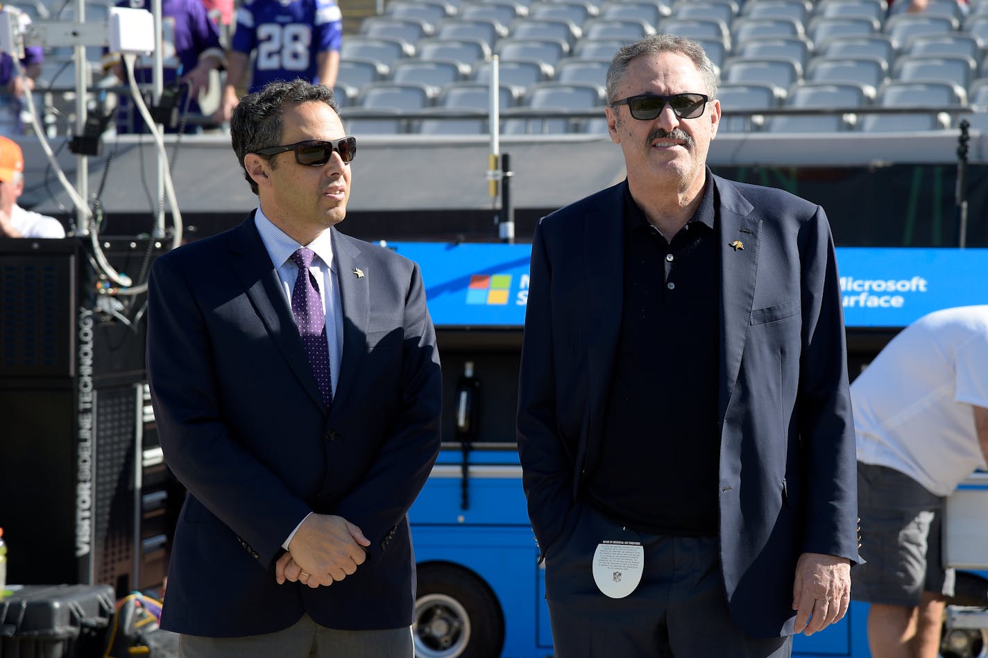 Minnesota Vikings owners Mark Wilf, left, and Zygi Wilf watch warmups on the sideline before an NFL football game against the Jacksonville Jaguars in Jacksonville, Fla., Sunday, Dec. 11, 2016. (AP Photo/Phelan M. Ebenhack)