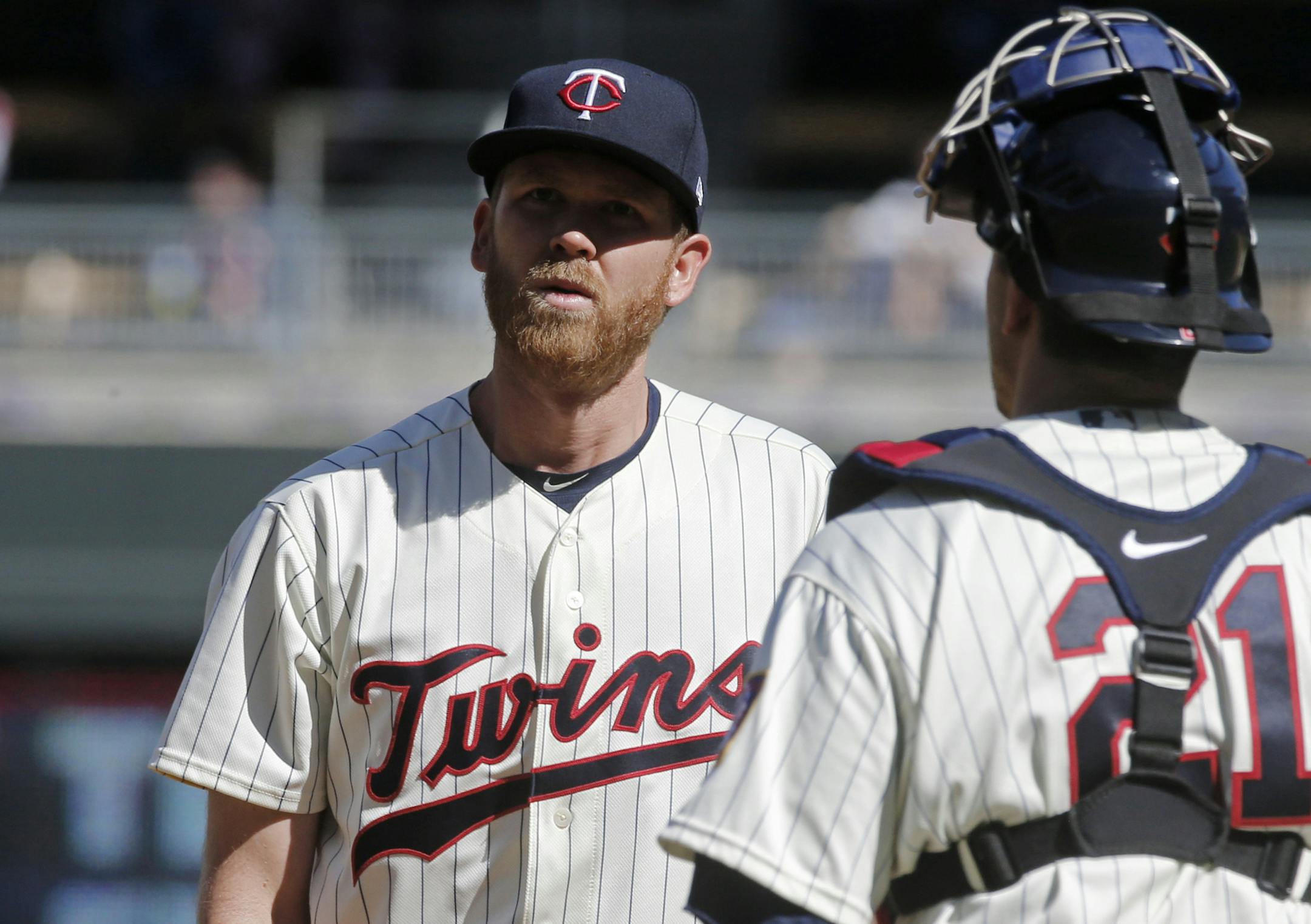 Minnesota Twins relief pitcher Michael Tonkin, left, gets a visit on the mount from catcher Jason Castro in the ninth inning of a baseball game Saturday, May 6, 2017, in Minneapolis. The Red Sox won 11-1. (AP Photo/Jim Mone)
