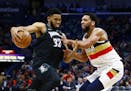 Minnesota Timberwolves center Karl-Anthony Towns (32) drives to the basket around New Orleans Pelicans center Jahlil Okafor (8) during the first half 