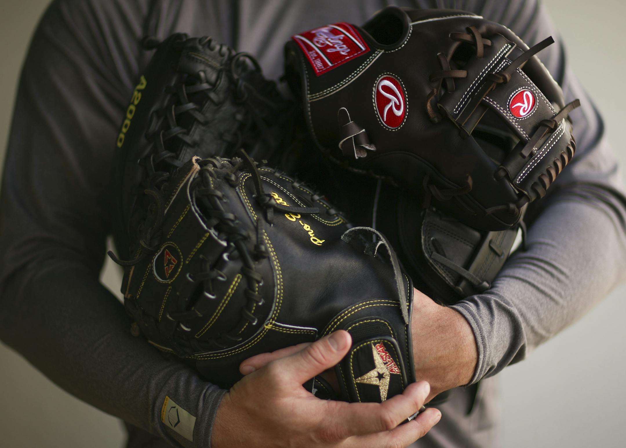 Twins catcher Chris Herrmann with all his gloves Wednesday afternoon at Hammond Stadium in Fort Myers. ] JEFF WHEELER ï jeff.wheeler@startribune.com The Twins played their first exhibition baseball game against the University of Minnesota team Wednesday night, March 4, 2015, at Hammond Stadium in Fort Myers, FL.
