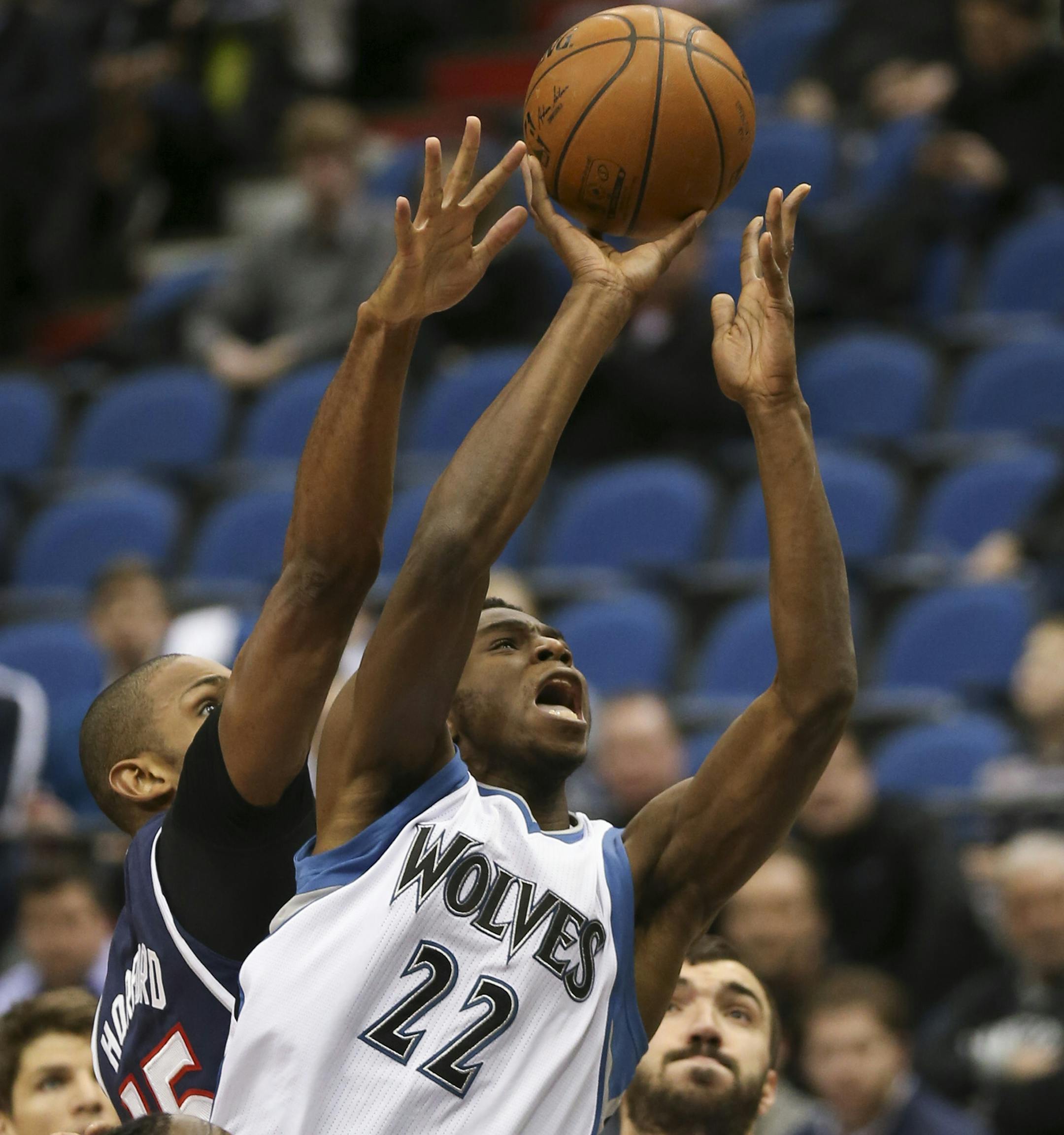 Timberwolves forward Andrew Wiggins was fouled from behind by Hawks center Al Horford (15) as he took a first-quarter shot.