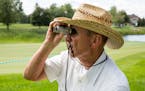 Jim O�Meara watches the third hole through his binoculars during round one of the 3M Championship at TPC Twin Cities on Friday.