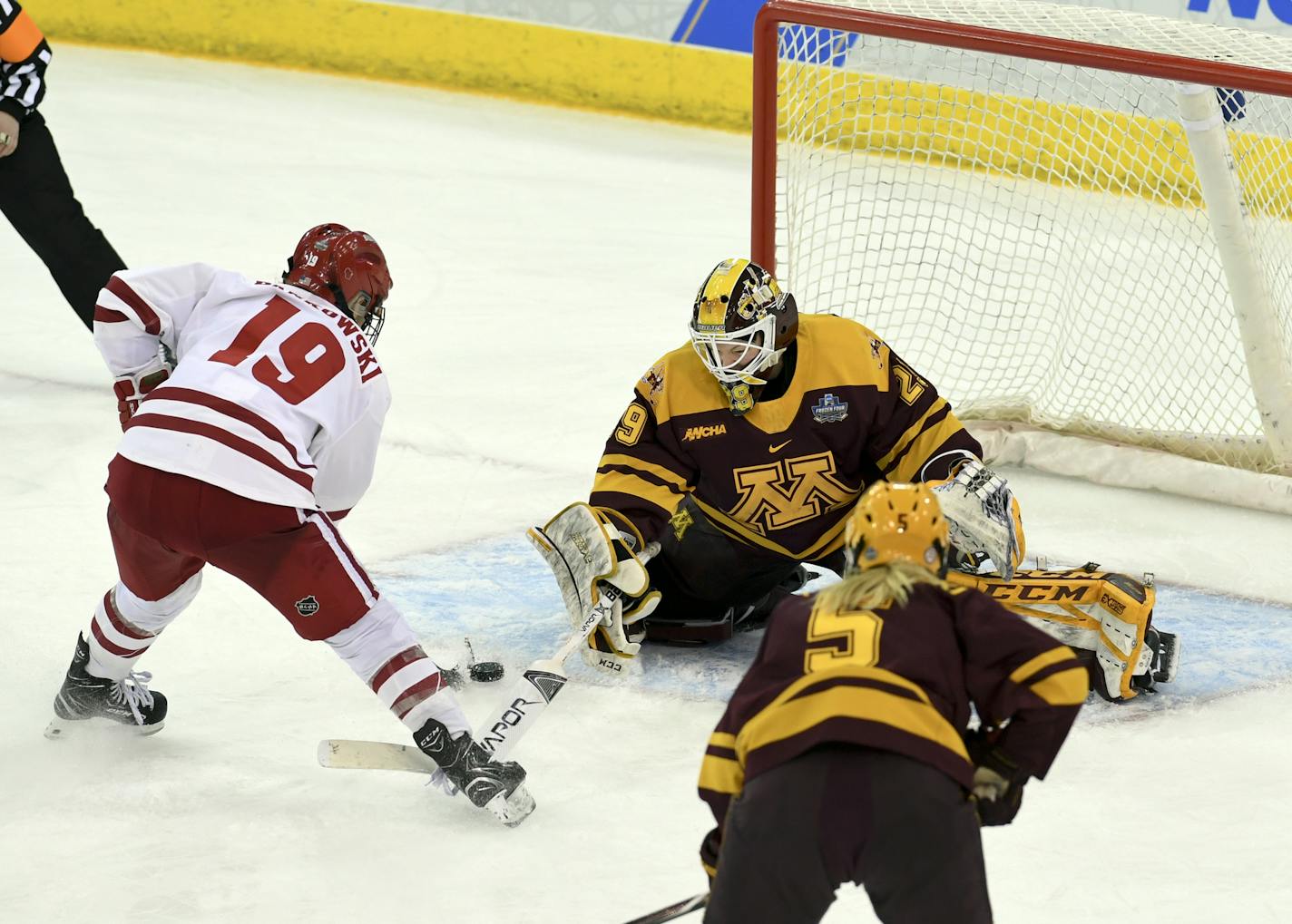 Wisconsin's Annie Pankowski (19) takes a shot on goal against Minnesota goaltender Alex Gulstene (29) during the second period in the NCAA Division I women's Frozen Four hockey championship game, Sunday, March 24, 2019, in Hamden, Conn. (AP Photo/Stephen Dunn)