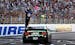 Kevin Harvick raised his arms toward fans after winning a NASCAR Cup Series auto race at New Hampshire Motor Speedway in Loudon, N.H., on Sunday.