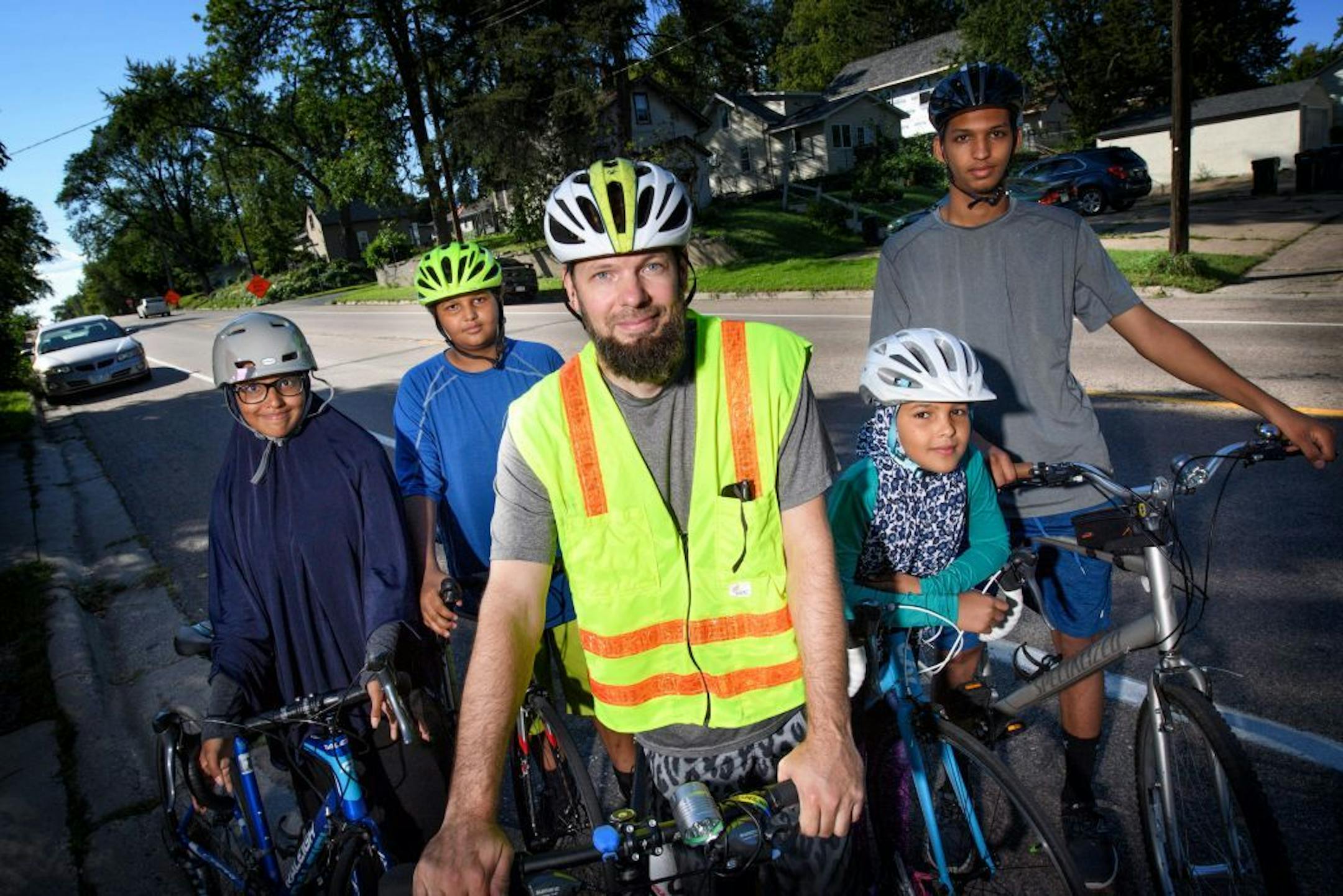 Brian Jakubowski with four of his 5 children, Sara, 15, Abdurrahman, 13, Sumayah, 11 and Abdul, 17. They found the envelope of cash and checks here in the middle of 44th Ave NE in Columbia Heights about one mile from their home.
