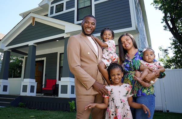 Jovonta Patton and his wife, Symone, are pictured with daughters Ella, 5, Zoey, 3, and baby Cali in front of the new home they purchased a few months 