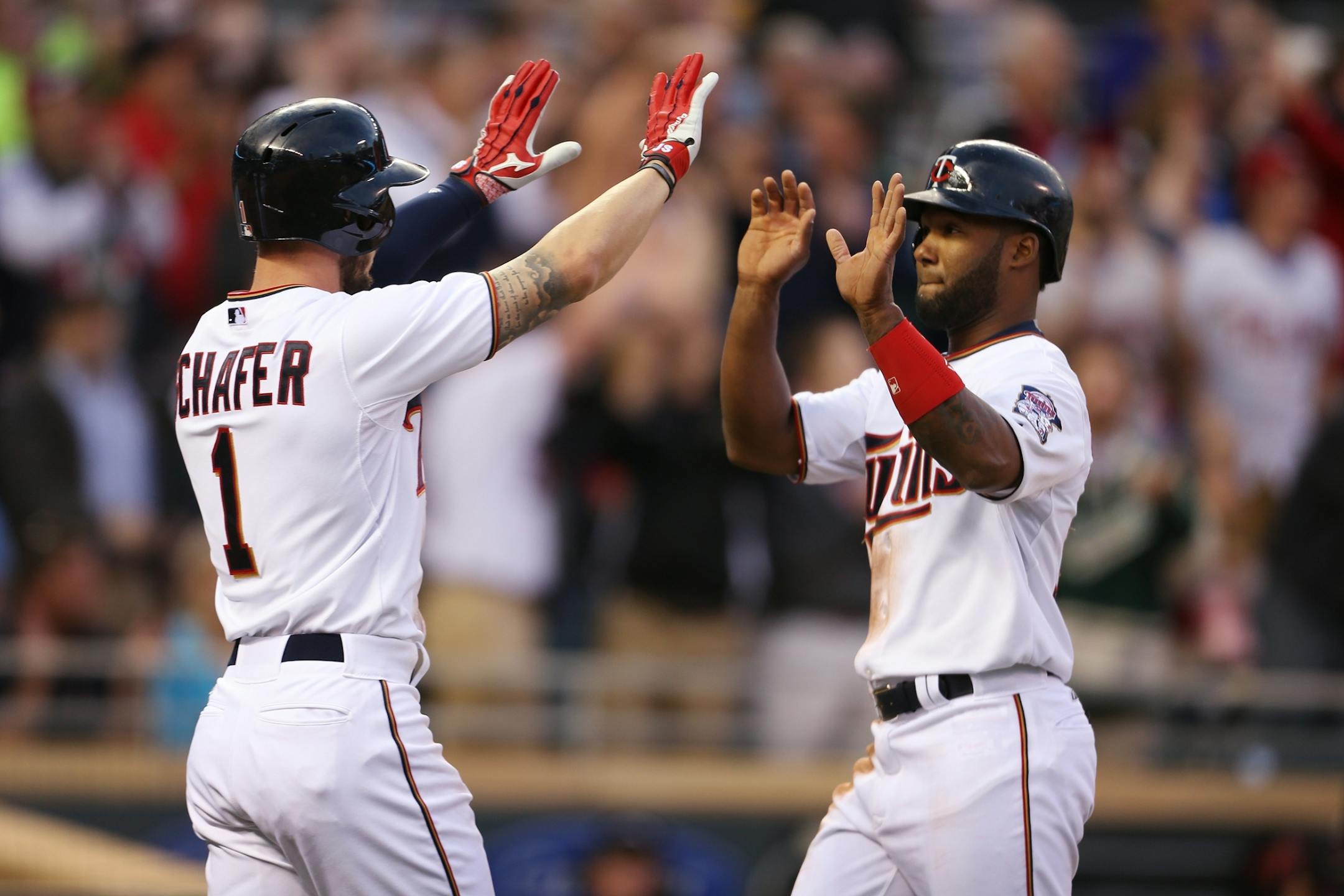 Jordan Schafer, left, and Danny Santana of the Twins celebrate scoring in the second inning against the Oakland Athletics at Target Field in Minneapolis on Monday, May 4, 2015.