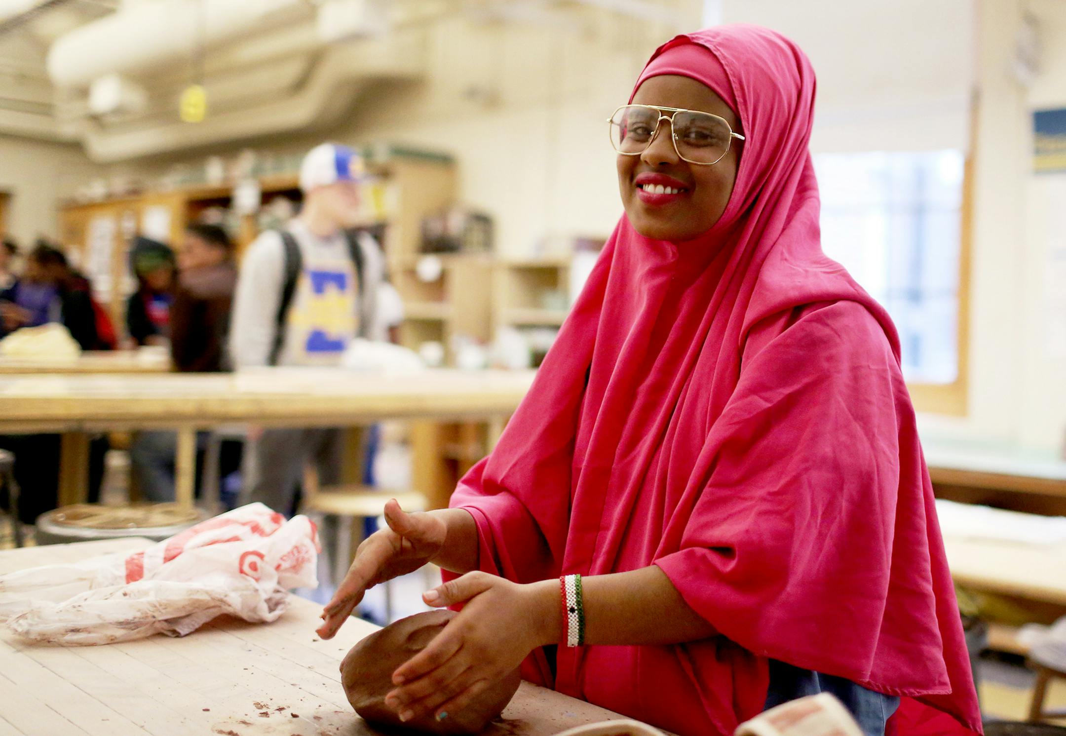 Najmo, an 11th-grader, talked about the Empty Bowls NE fundraiser while wedging clay at Edison High School.