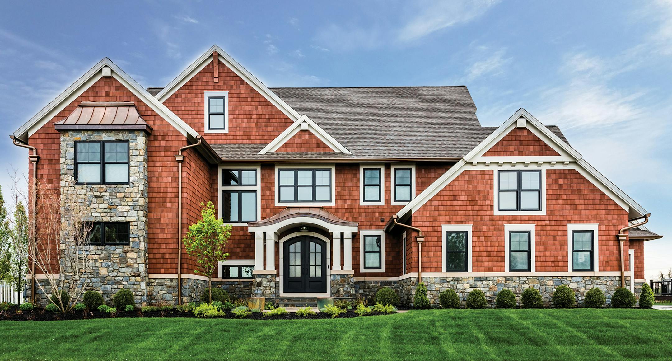 Home plan: A combination of shingle and stone delivers grand curb appeal to this Craftsman design.