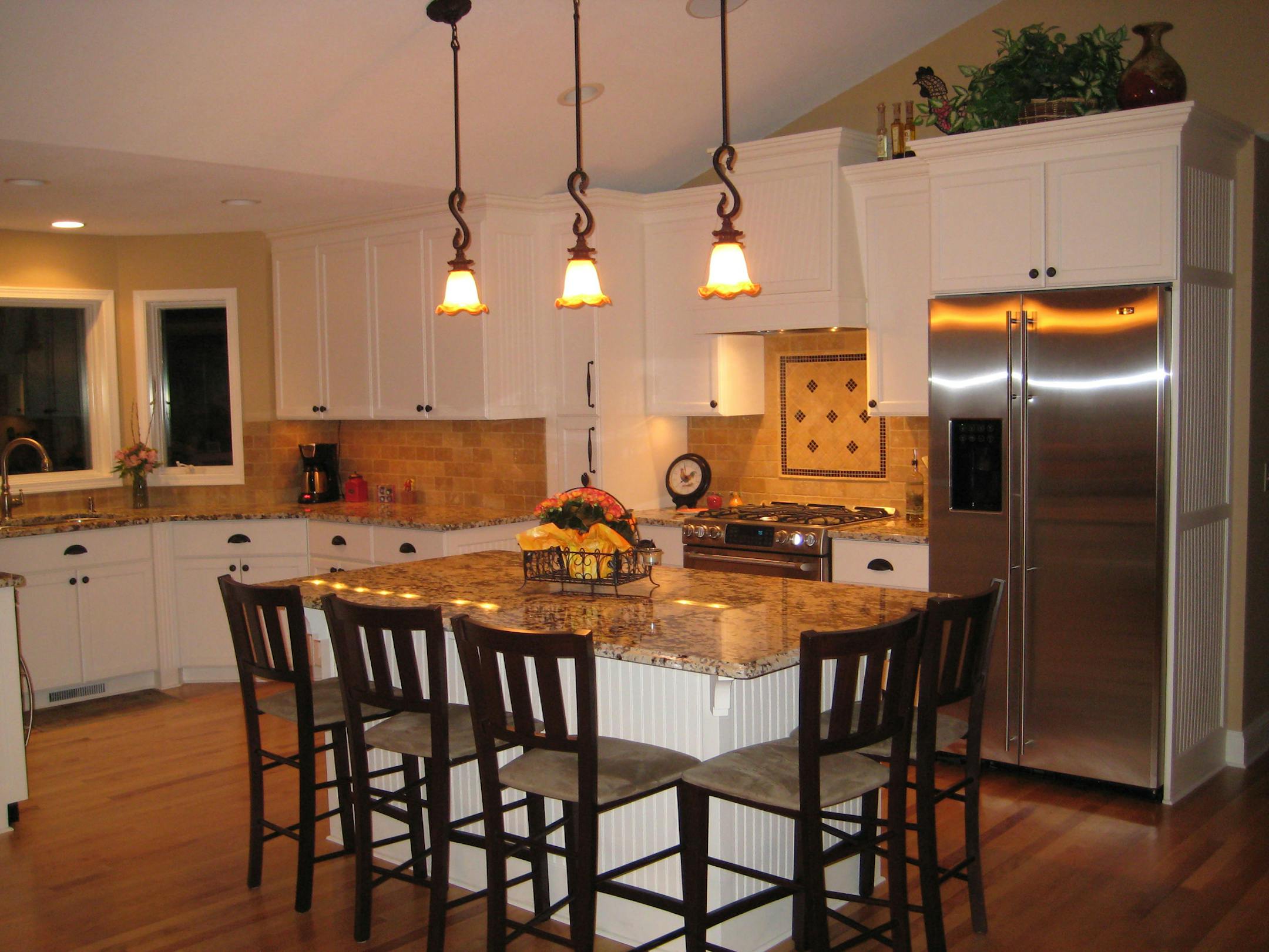 After: Priem had a wall removed between the kitchen and dining room and a new island does triple duty as kitchen work space, an eating area and a homework spot for her two children.