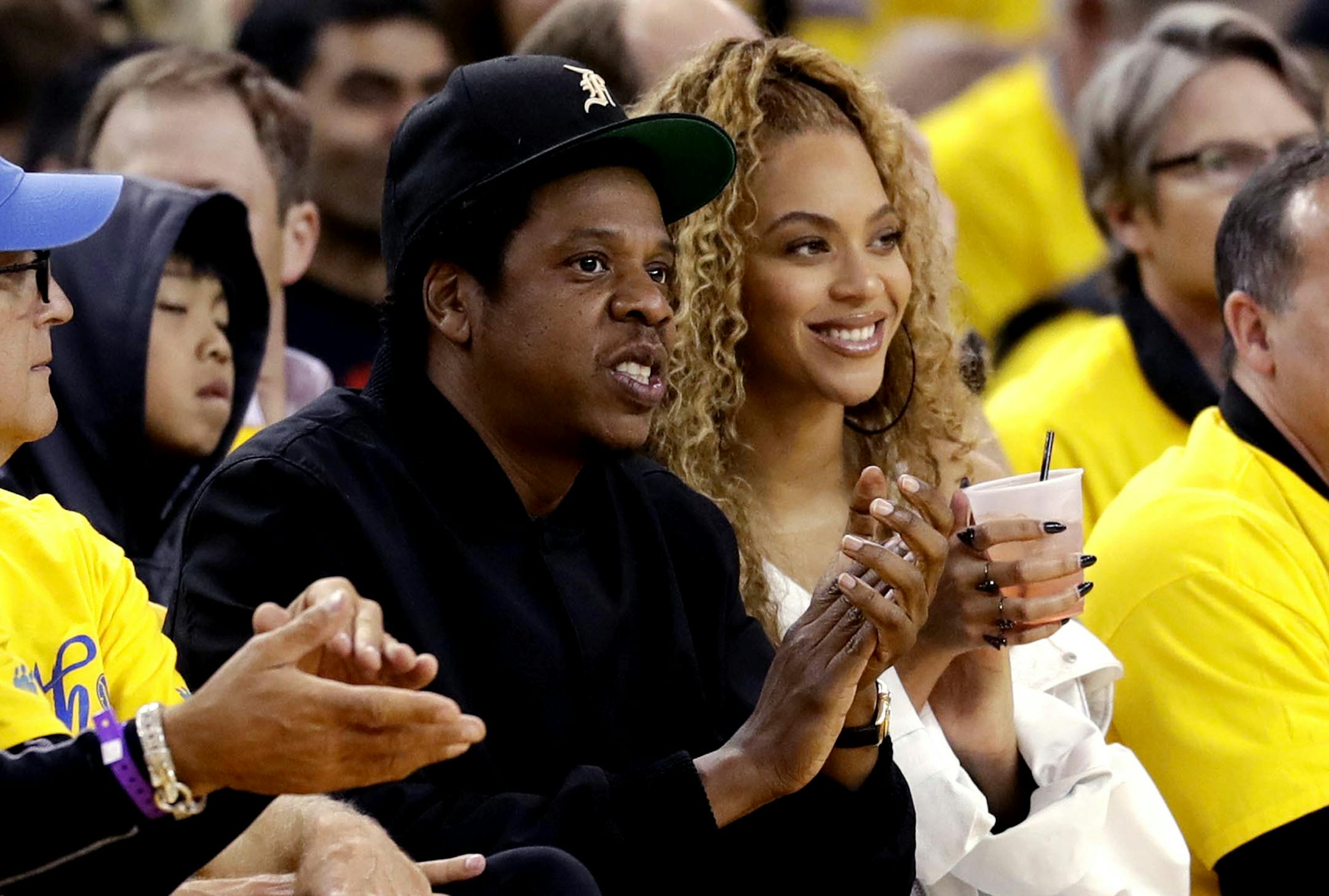 FILE - In this April 28, 2018, file photo, Jay-Z and Beyonce watch Game 1 of an NBA basketball second-round playoff series between the Golden State Warriors and the New Orleans Pelicans in Oakland, Calif. Several top record labels organized Black Out Tuesday on June 2, 2020 as riots erupted around the world sparked by Floyd's death as well as the killings of Ahmaud Arbery and Breonna Taylor. Musicians including Rihanna, Beyoncé, Taylor Swift, Lil Nas X, Demi Lovato, Post Malone and Harry Styles