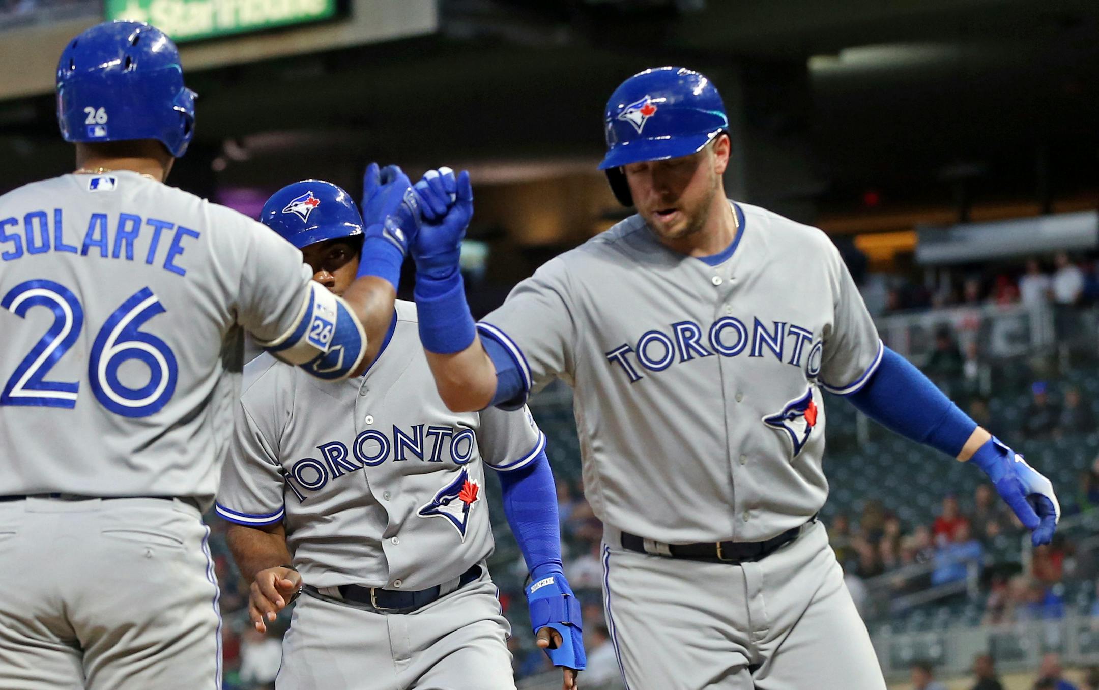 The Blue Jays' Justin Smoak, right, was congratulated by Yangervis Solarte after Smoak's two-run home run off Twins starter Lance Lynn in the fourth inning Monday.