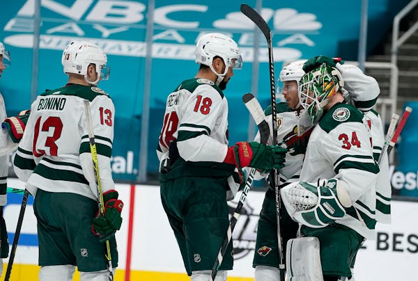 Minnesota Wild goaltender Kaapo Kahkonen (34) is congratulated by teammates after their victory over the San Jose Sharks in an NHL hockey game in San 