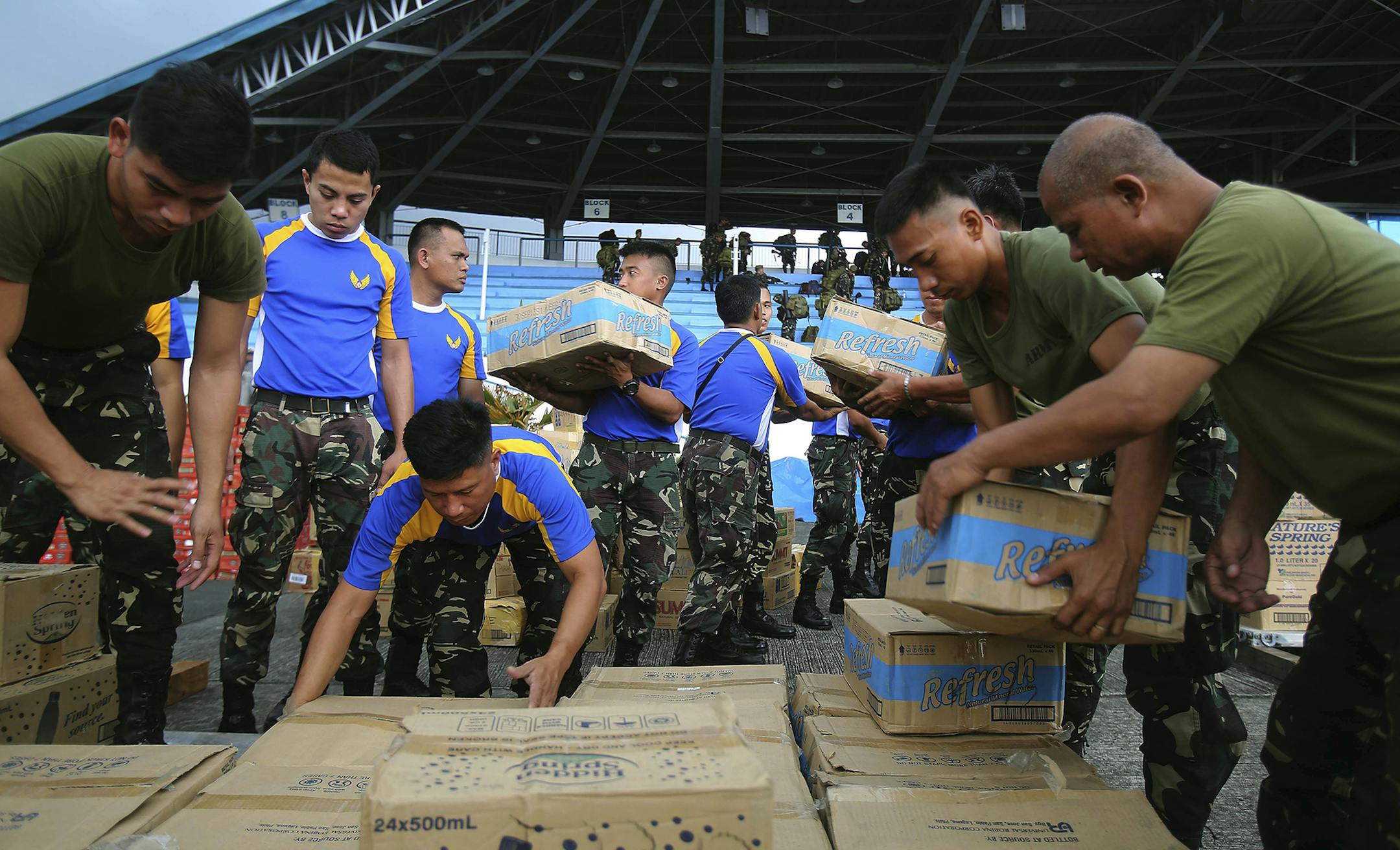 Philippine soldiers pack relief supplies for victims of Typhoon Haiyan at Villamor Airbase, Tuesday, Nov. 12, 2013 in Manila, Philippines. Authorities said at least 9.7 million people in 41 provinces were affected by the typhoon, which was likely the deadliest natural disaster to beset this poor Southeast Asian nation. (AP Photo/Wong Maye-E) ORG XMIT: MIN2013111213581807