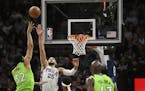 Minnesota Timberwolves center Karl-Anthony Towns (32) hit a basket over Philadelphia 76ers guard Ben Simmons (25) in the second half.