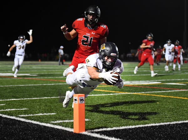 Prior Lake wide receiver Joey Krouse (23) leapt for a touchdown after a reception as he was trailed by Shakopee linebacker Tyrus Laden (21) in the thi