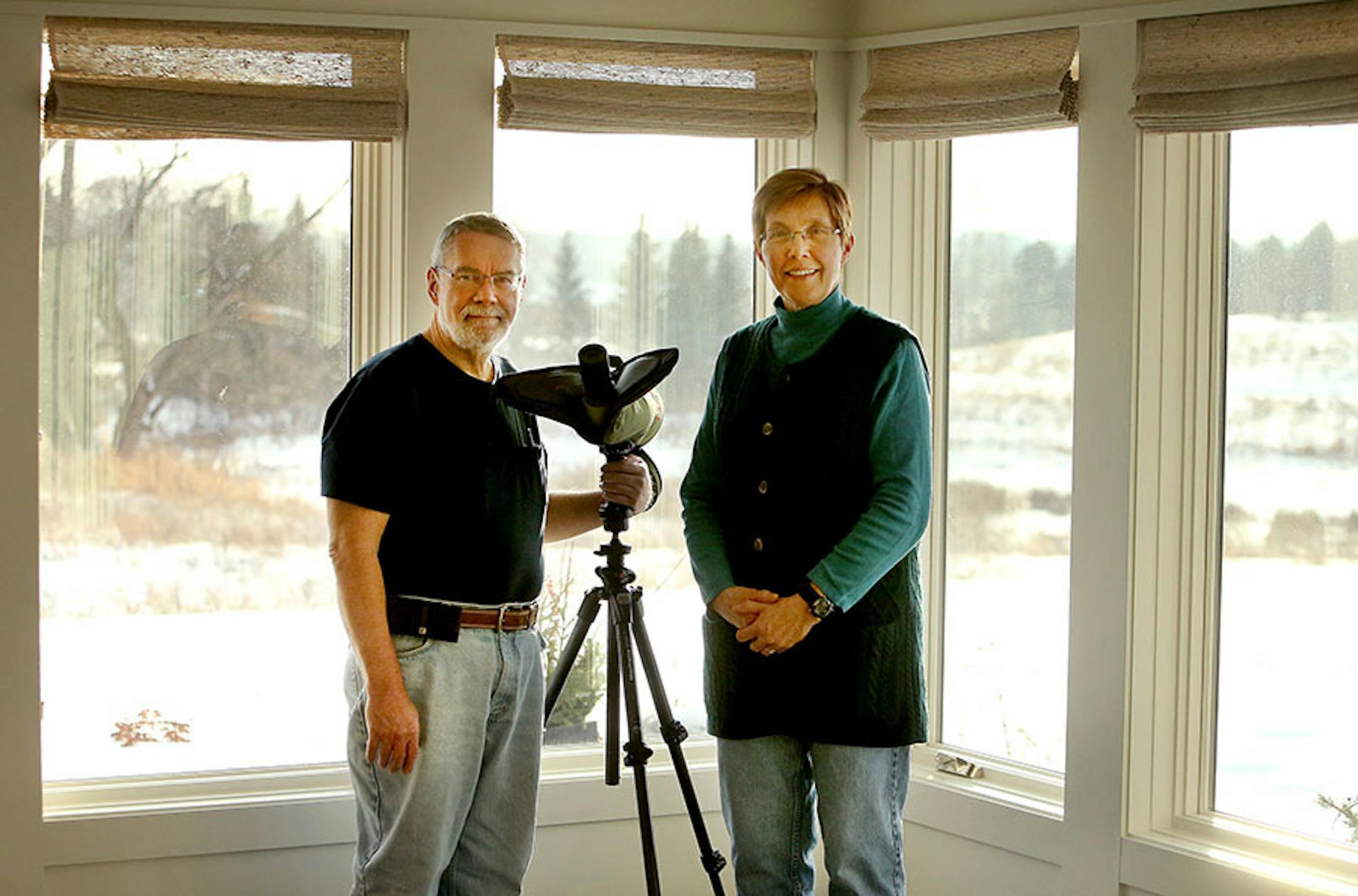 Susan and Jeff Saffle's passion for birdwatching and nature drove the design of this Scandinavian version of a Prairie Modern home in Lake Elmo by Rehkamp Larson Architects. Here, Jeff and Susan Saffle can watch birds and animals through the numerous windows in the front of their home that give them a sweeping view of the prairie and nearby pond outside their residence Wednesday, Jan. 13, 2016, in Lake Elmo, MN.