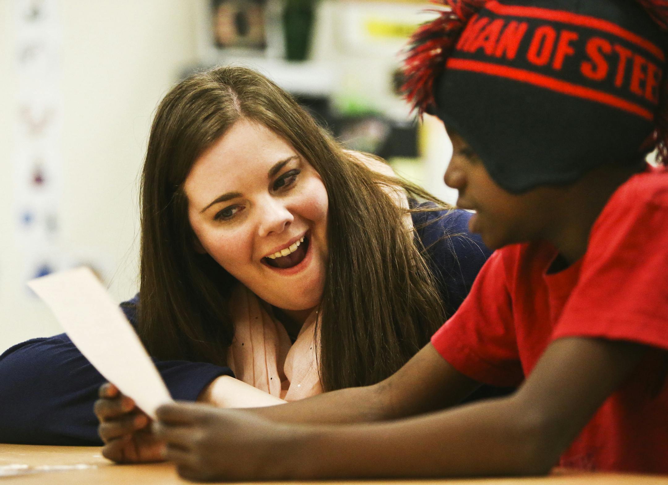 Samantha Ovadal, an EA at John Glenn Alternative Program with a bachelor's degree in sociology, listens to a student in a K-5 class talk about a Thor-like superhero he created for a class project Tuesday, April 22, 2014, at John Glenn Alternative Learning Program in Maplewood, MN. Ovadal will be heading to the U of M in the fall to earn a Master's degree in education while working as an EA at the school to combat a state shortage of special education teachers that often causes schools to put unq
