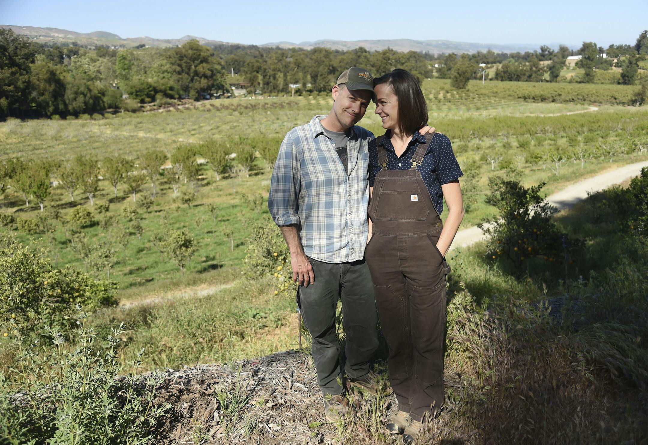 This April 17, 2019 photo shows John Chester, left, and his wife Molly, of the documentary film "The Biggest Little Farm," at Apricot Lane Farms in Moorpark, Calif. (Photo by Chris Pizzello/Invision/AP)