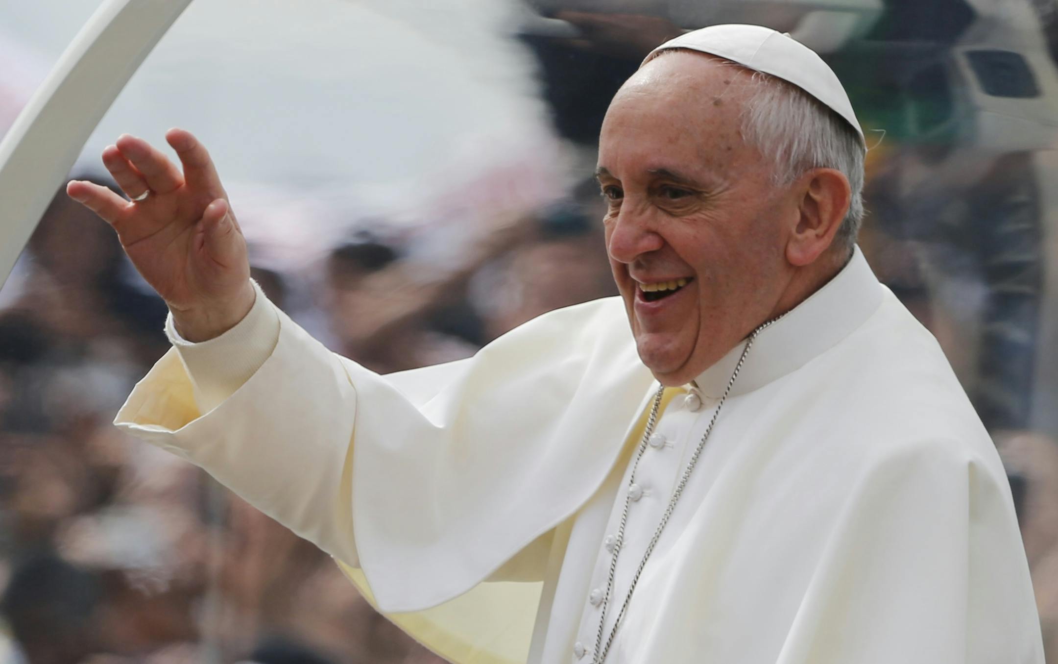 Pope Francis waves from his popemobile along the Copacabana beachfront on his way to celebrate Mass in Rio de Janeiro, Brazil, Sunday, July 28, 2013. Hundreds of thousands of young people slept under chilly skies in the white sand awaiting Francisí final Mass for World Youth Day. (AP Photo/Jorge Saenz) ORG XMIT: MIN2013080515030837