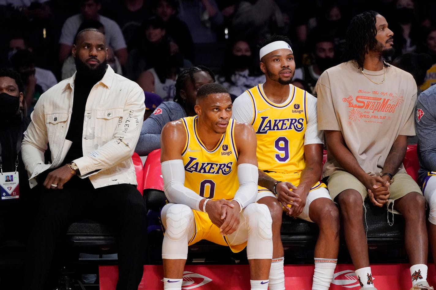 Lakers forward LeBron James, left, sits on the bench next to guard Russell Westbrook, forward Kent Bazemoreand forward Trevor Ariza