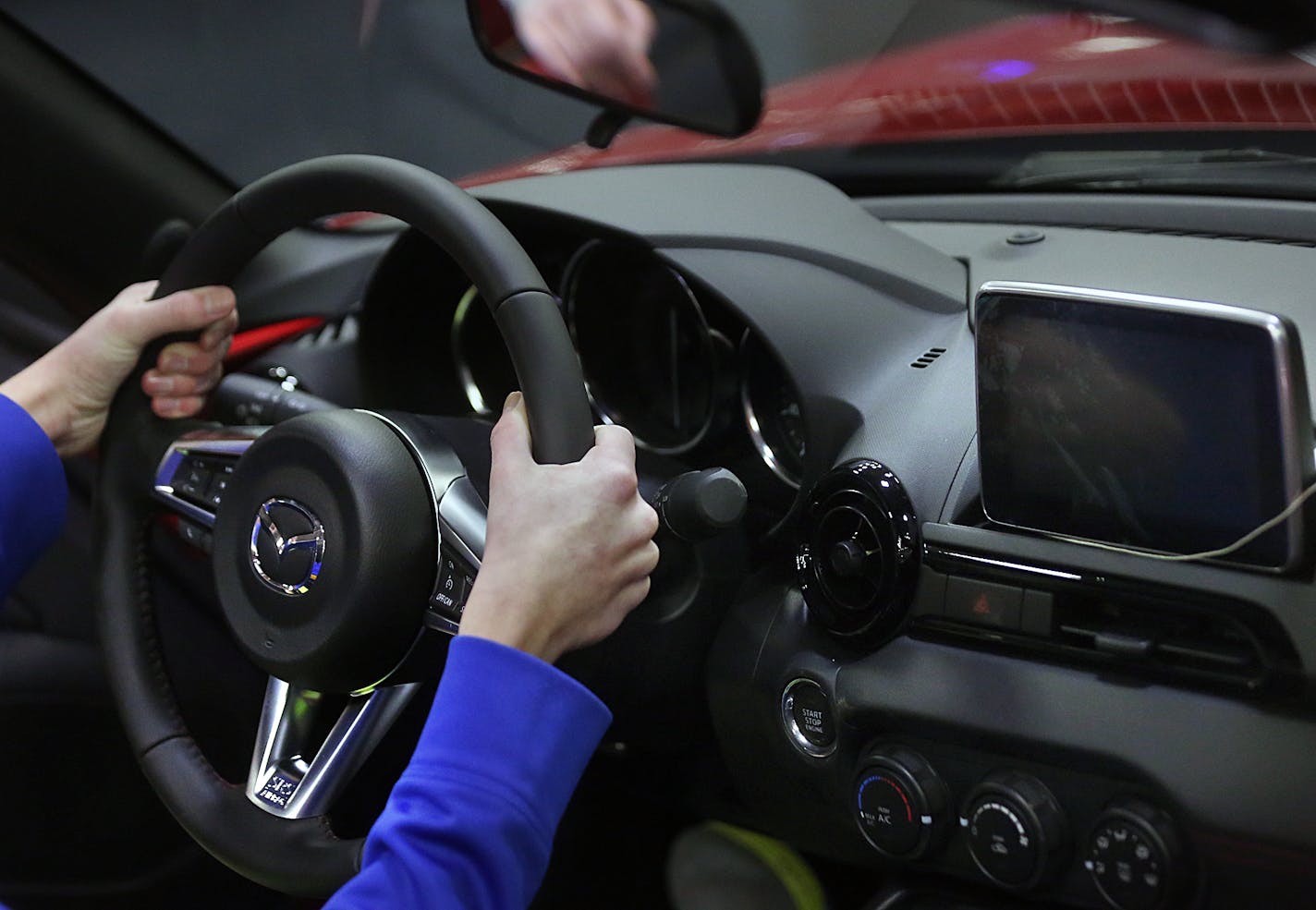 Automobile enthusiasts explored the features on a sporty, 2016 Mazda MX-5 Miata, with an MSRP of $33,135. ] JIM GEHRZ &#xef; james.gehrz@startribune.com /Minneapolis, MN / March 12, 2016 /10:00 AM - BACKGROUND INFORMATION: Please attend the media preview of the Twin Cities Auto Show for a story focusing on new tech features in cars. Preview is 10a-12p Saturday March 12. Reporter Katy Read is there. http://twincitiesautoshow.com/show-info/schedule