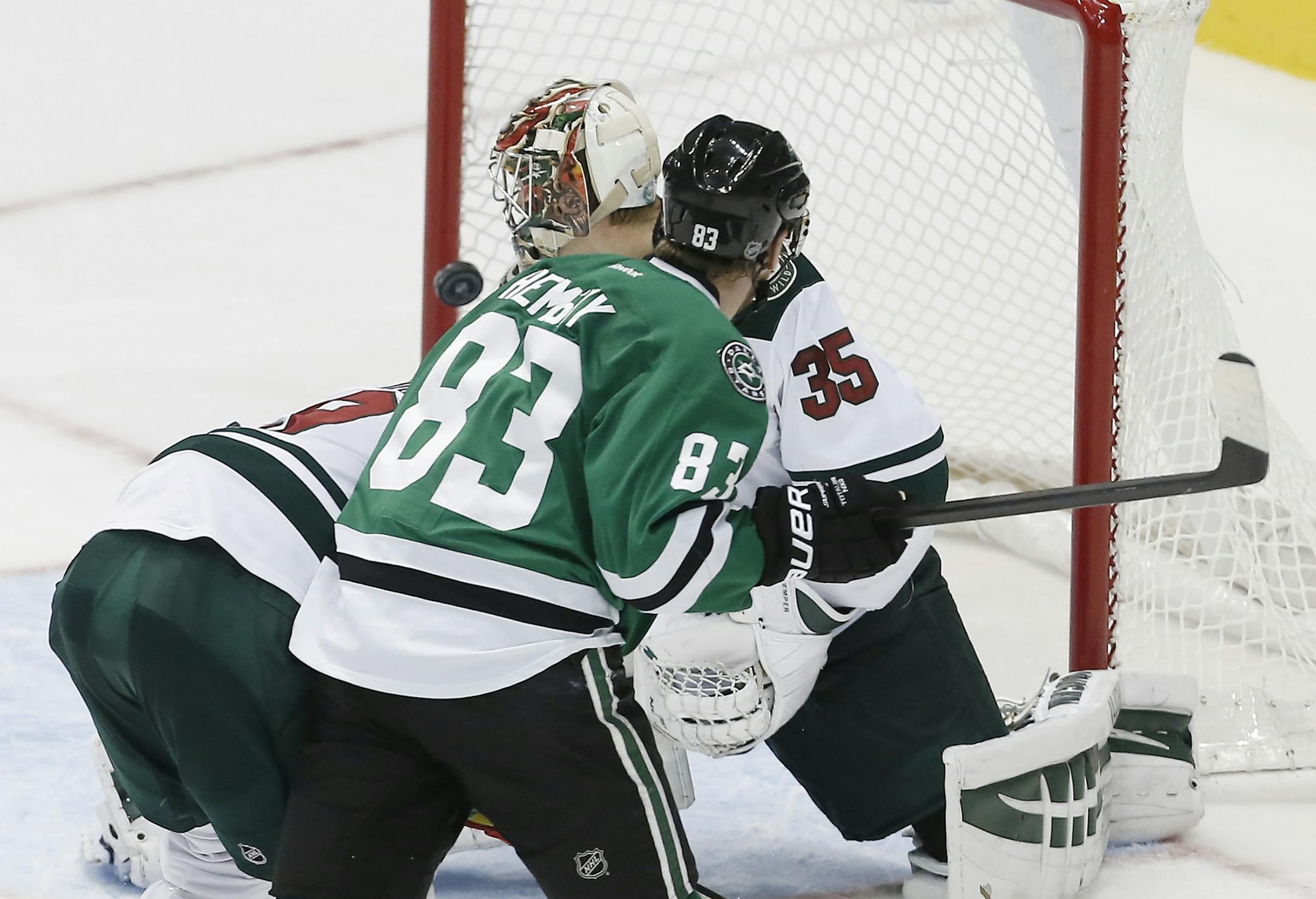 Dallas Stars Ales Hemsky (83) shoots the puck past Minnesota Wild goalie Darcy Kuemper (35) for a goal as forward Mikko Koivu (9) attempts to defend in the second period of an NHL hockey game, Friday, Nov. 28, 2014, in Dallas.
