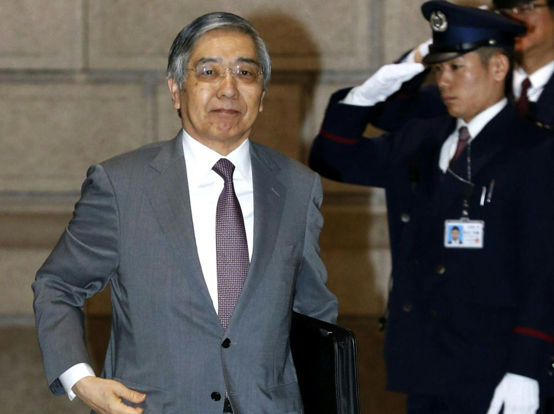 Bank of Japan Gov. Haruhiko Kuroda, left, arrives for a meeting at the BOJ's head office in Tokyo, Wednesday, April 8, 2015. Two years after launching a bazooka of ultra-lavish monetary easing, Bank of Japan Gov. Kuroda has made only fitful progress toward the goal of the 2 percent inflation rate he and Prime Minister Shinzo Abe said was needed to jolt the worldís No. 3 economy out of its deflationary rut. (AP Photo/Kyodo News) JAPAN OUT, MANDATORY CREDIT