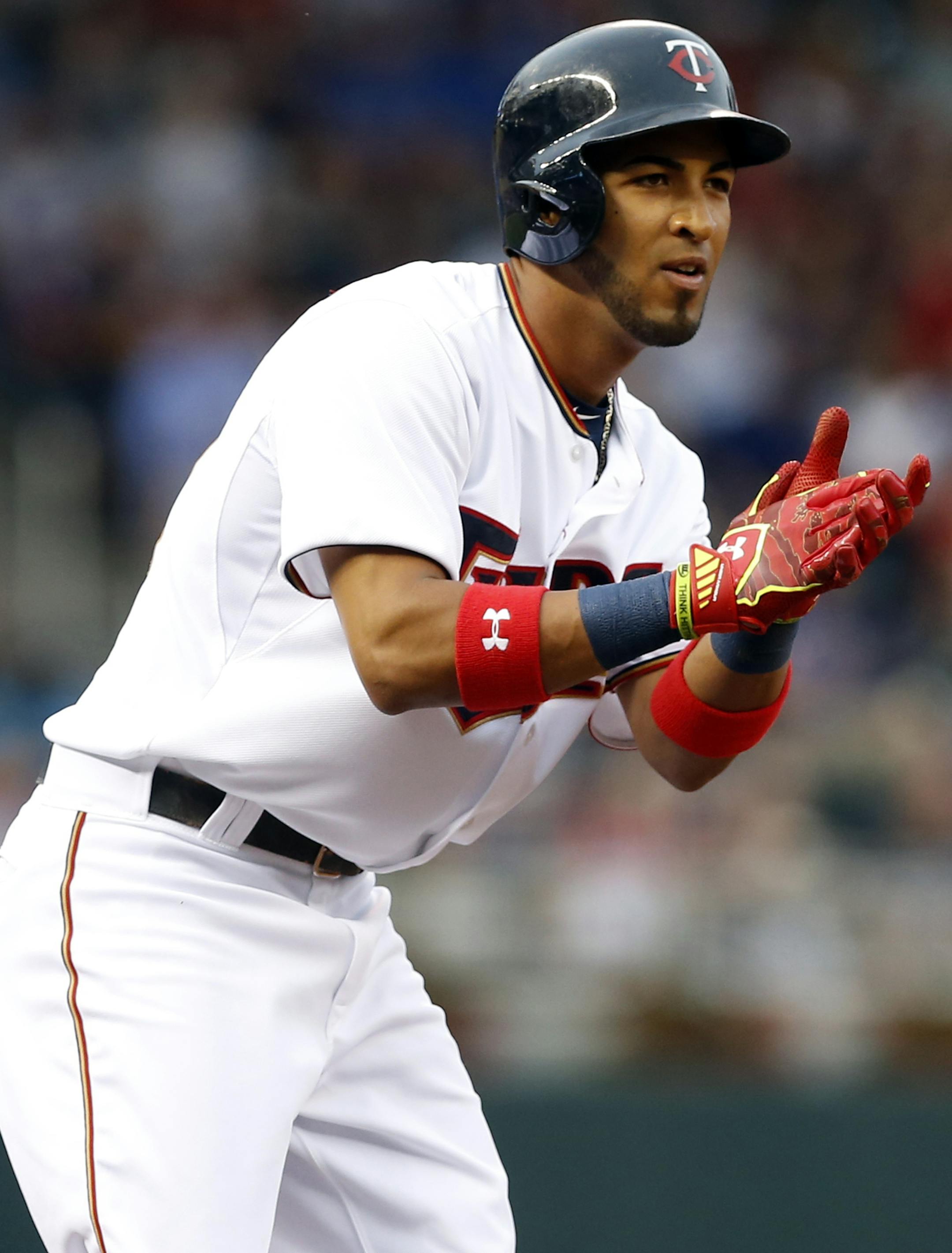 Minnesota Twins’ Eddie Rosario celebrates his triple off Chicago Cubs pitcher Kyle Hendricks in the third inning of a baseball game, Friday, June 19, 2015, in Minneapolis. (AP Photo/Jim Mone)