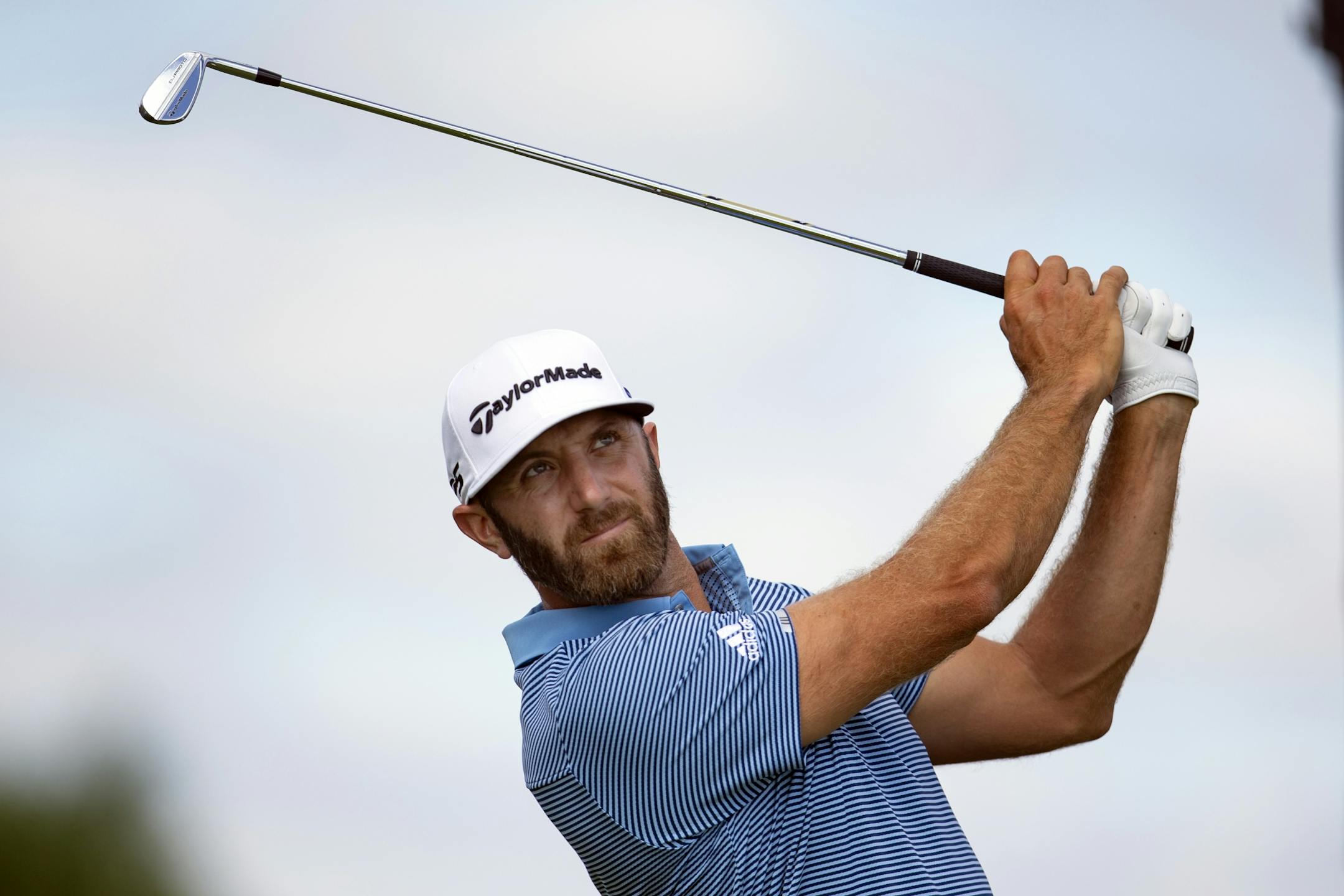 Dustin Johnson tees off on the fourth hole during the first round of the 3M Open golf tournament in Blaine, Minn., Thursday, July 23, 2020.